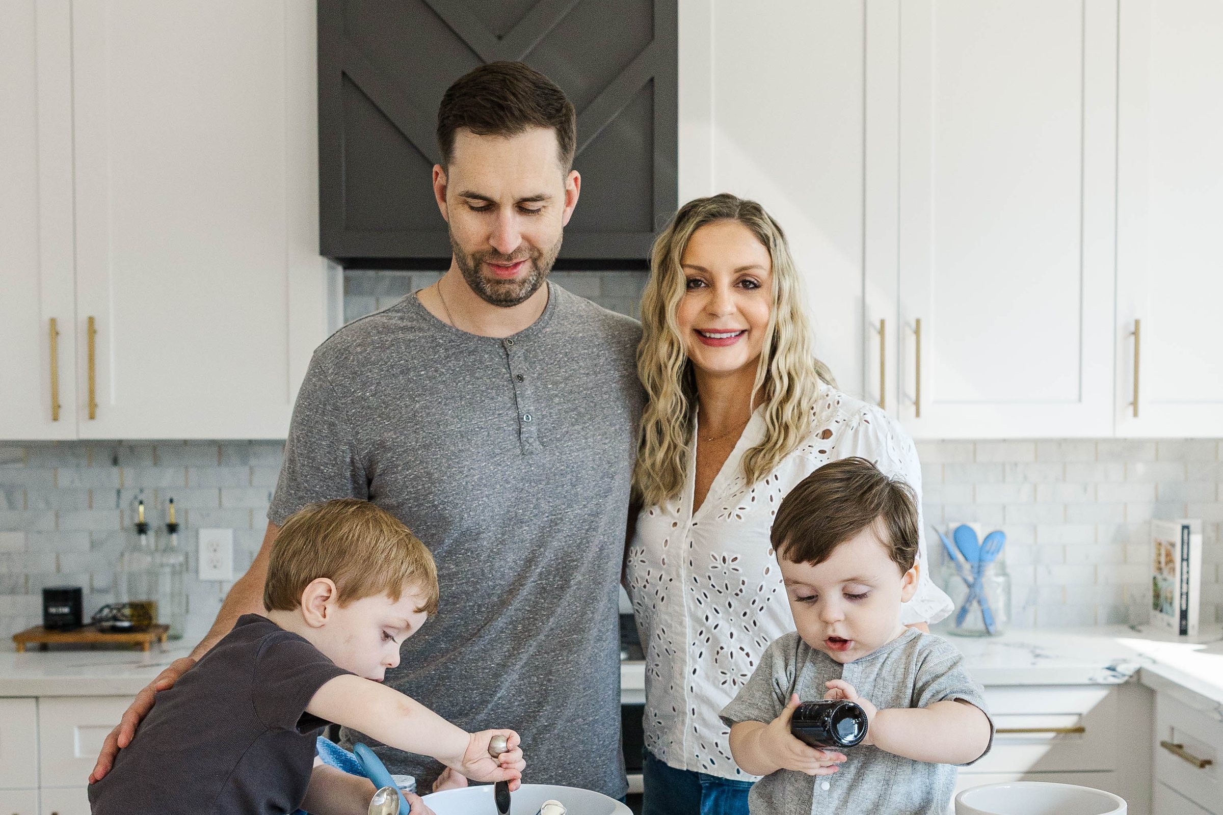 Amanda, founder of Part Time Nanny, with her family in the kitchen